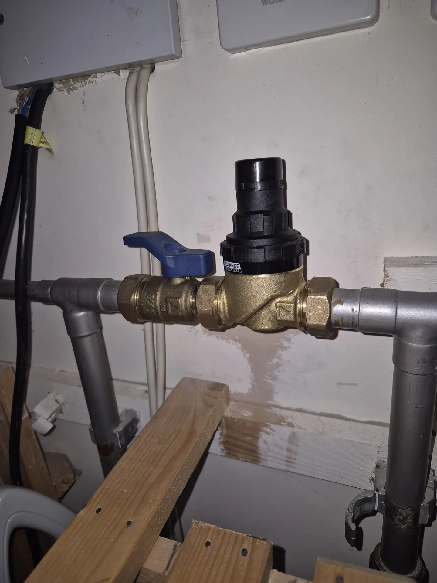 Brass pressure-reducing valve fitted by a plumber in Romford