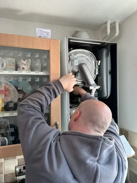 Mitchell Braxton working on a gas boiler