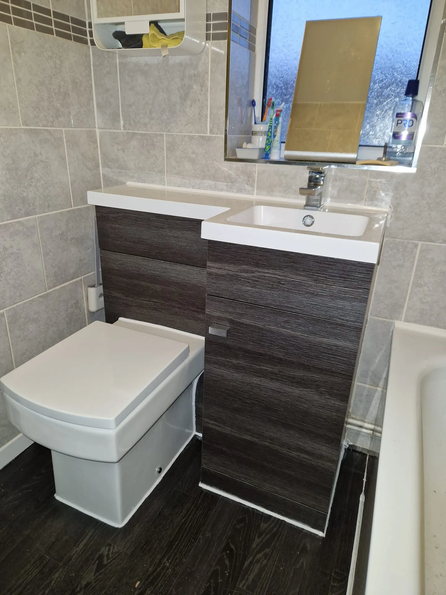 Modern bathroom installation with vanity basin and bath in Romford